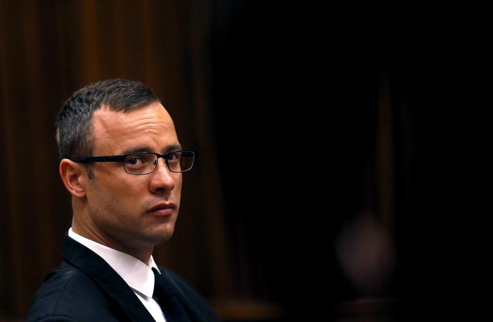 Olympic and Paralympic track star Oscar Pistorius sits in the dock ahead of his trial for the murder of his girlfriend Reeva Steenkamp, in Pretoria