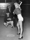 <p>Marilyn Monroe takes a swing at baseball during a 20th Century Fox studio league game, July 1, 1952.</p>