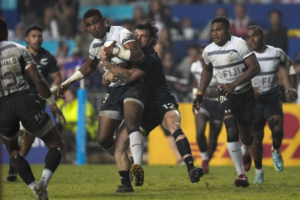 Fiji's Pilipo Bukayaro is tackled by New Zealand's Leroy Carter during the final match in the Hong Kong Sevens rugby tournament in Hong Kong, Sunday, April 2, 2023. (AP Photo/Louise Delmotte)