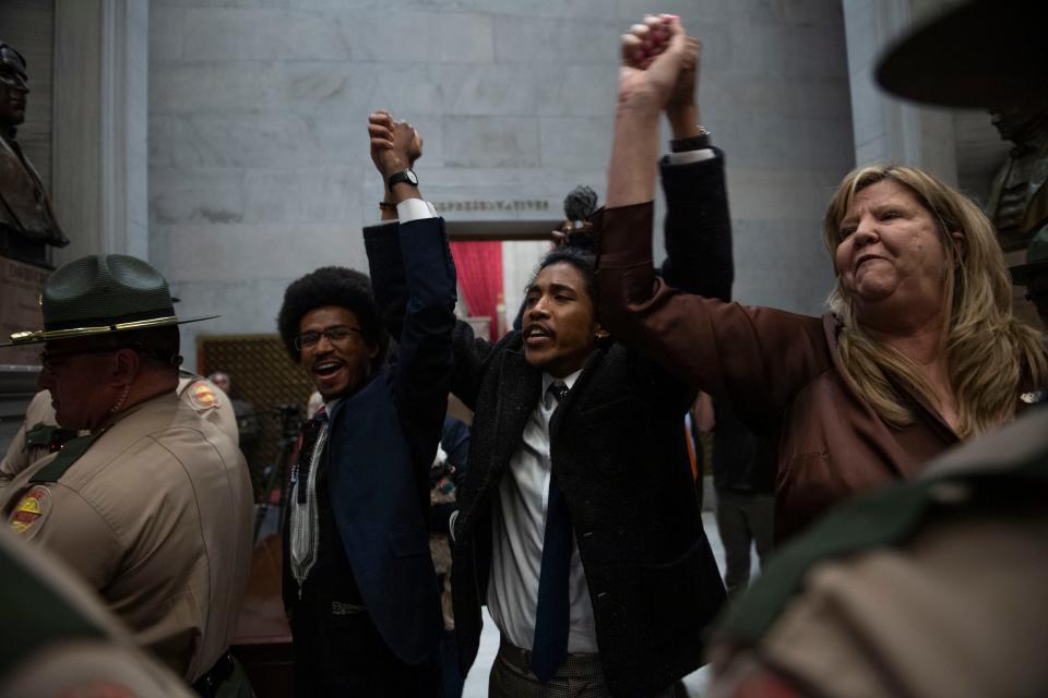 Democratic Reps. Justin Pearson of Memphis, Rep. Justin Jones of Nashville, Rep. Gloria Johnson of Knoxville hold their hands up as they exit the House chamber doors at Tennessee state Capitol Building in Nashville, Tennessee, Monday, April 3, 2023.