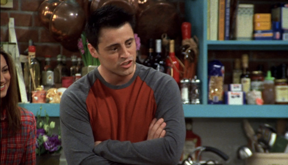 close up of joey with rachel's stand in seen in the corner