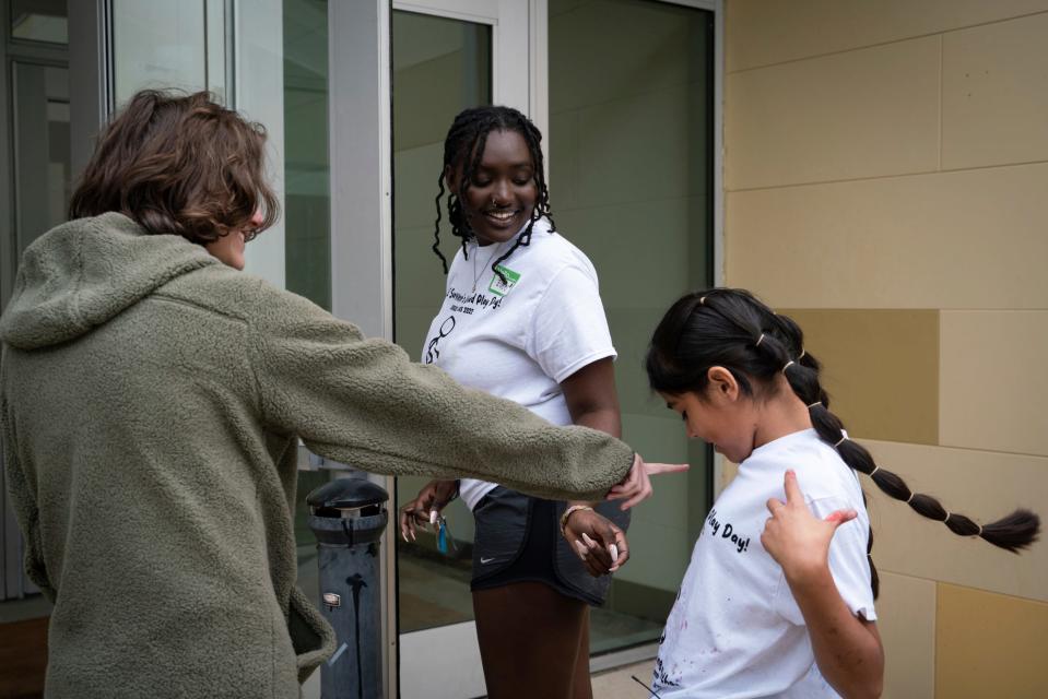 School shooting survivors and activists Zoe Weissman, 16, of Florida, left, Zoe Touray, 18, of Pontiac, Michigan, and Caitlyne Gonzales, 10, of Uvalde, Texas, joke after meeting each other for the first time at SSGT Willie de Leon Civic Center in Uvalde, Texas on Saturday, Nov. 19, 2022.