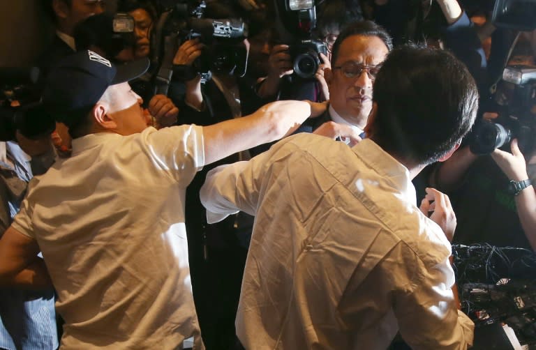 Atar Safdar (C), the head of Oxy Reckitt Benckiser Korea, is surrounded by angry relatives of victims during a press conference in Seoul, on May 2, 2016