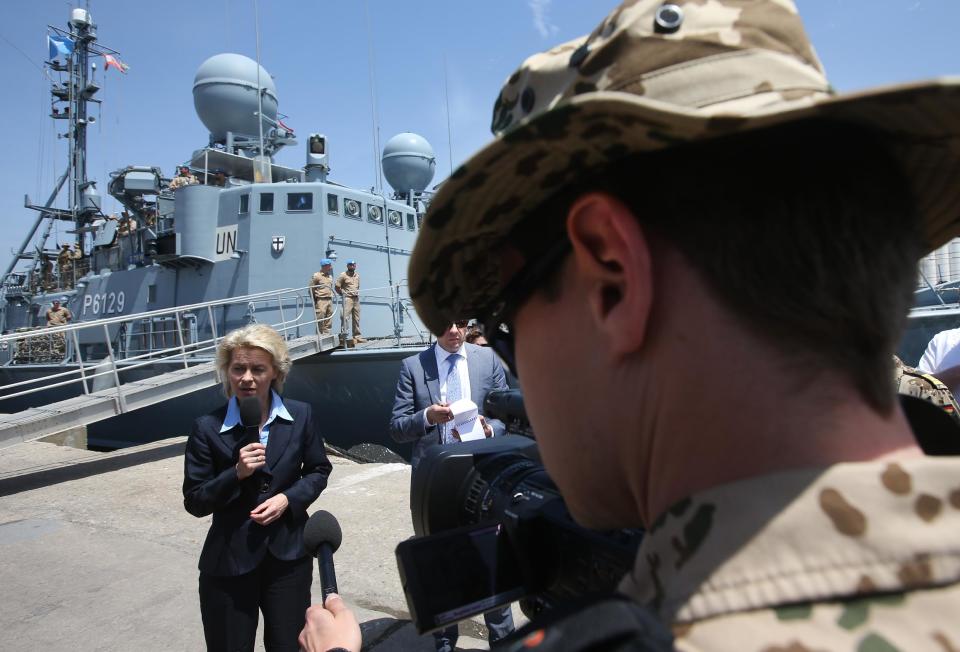 A U.N peacekeeper German navy cameraman, right, films German Defense Minister Ursula von der Leyen, left, who stands in front of a German UNIFIL vessel as she reads a statement, at the seaport of Beirut, Lebanon, Thursday April 24, 2014. Leyen is in Lebanon to meet with Lebanese officials and to visit to the German UNIFIL navy troops. (AP Photo/Hussein Malla)