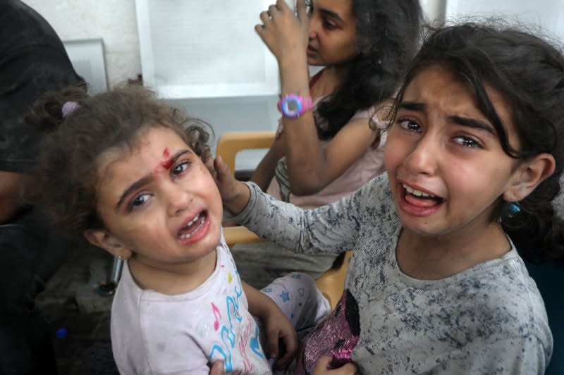 Injured Palestinian children wait at a hospital to be examined after an Israeli airstrike on their home in Rafah, the southern Gaza Strip on Thursday. Photo by Ismael Mohamad/UPI