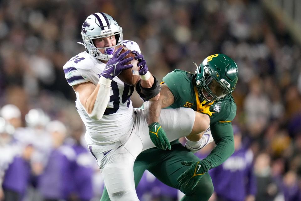 Kansas State tight end Ben Sinnott (34) catches as pass in front of Baylor's Jackie Marshall (35) during their game last year in Waco, Texas.