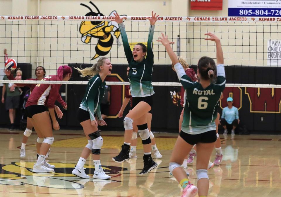 Royal High's Ayzlinn Trefren celebrates with teammates Carly Ballentine and Shae Rizzo after blocking a shot during their match against Oxnard on Saturday, Sept. 24, 2022, at Oxnard High.