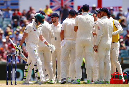 Cricket - Ashes test match - Australia v England - WACA Ground, Perth, Australia, December 17, 2017. Australia's captain Steve Smith walks past England players as they celebrate after their LBW appeal was successful, after the original decision of not out was overturned, during the fourth day of the third Ashes cricket test match. REUTERS/David Gray