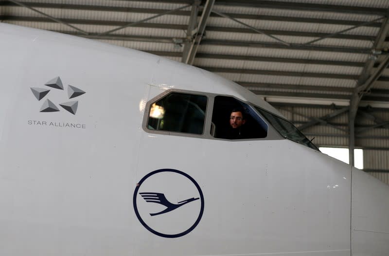 A technician looks out of the cockpit of a Lufthansa Airbus A330-300 aircraft in a maintenance hangar at Lufthansa Technik Malta at Malta International Airport outside Luqa