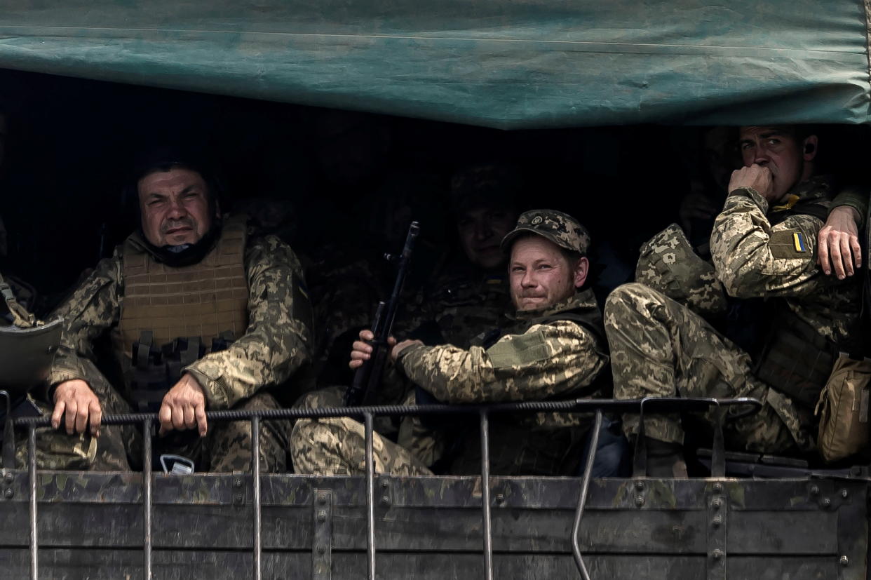 Service members of the Ukrainian armed forces on a military vehicle.