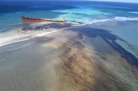 This photo taken and provided by Georges de La Tremoille of Mu Press shows oil leaking from the MV Wakashio, a bulk carrier ship that recently ran aground off the southeast coast of Mauritius, Friday, Aug. 7, 2020. The Indian Ocean island of Mauritius declared a “state of environmental emergency” late Friday after a Japanese-owned ship that ran aground offshore days ago began spilling tons of fuel. (Georges de La Tremoille/MU press via AP)