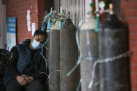 A COVID-19 patient receives oxygen outside an emergency ward at a government-run hospital in Kathmandu, Nepal, Thursday, May 13, 2021. (AP Photo/Niranjan Shrestha)