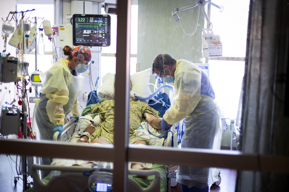 FILE - In this Aug. 31, 2021, file photo, Dr. William Dittrich M.D. looks over a COVID-19 patient in the Medical Intensive care unit (MICU) at St. Luke's Boise Medical Center in Boise, Idaho. An advocacy group for seniors has filed a civil rights complaint against Idaho over the state's "crisis standards of care" guidelines for hospitals overwhelmed during the coronavirus pandemic. Justice in Aging wants the U.S. Department of Health and Human Services to investigate Idaho's health care rationing plan, contending that it discriminates against older adults by using factors like age in prioritizing which patients may get access to life-saving care. (AP Photo/Kyle Green, File)