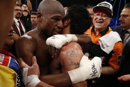 El estadounidense Floyd Mayweather (I) abraza al filipino Manny Pacquiao tras su victoria en la Pelea del Siglo, el 2 de mayo de 2015, en el MGM Grand Garden Arena en Las Vegas, Nevada (AFP | JOHN GURZINSKI)