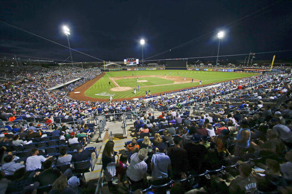 FILE - In this Thursday, March 12, 2015 file photo, Peoria Sports Complex Stadium host a spring training night baseball game between the San Diego Padres and Los Angeles Dodgers in Peoria, Ariz. Putting all 30 teams in the Phoenix area this season and playing in empty ballparks was among the ideas discussed Monday, April 6, 2020 during a call among five top officials from MLB and the players' association that was led by Commissioner Rob Manfred, people familiar with the discussion told The Associated Press. (AP Photo/Lenny Ignelzi, File)