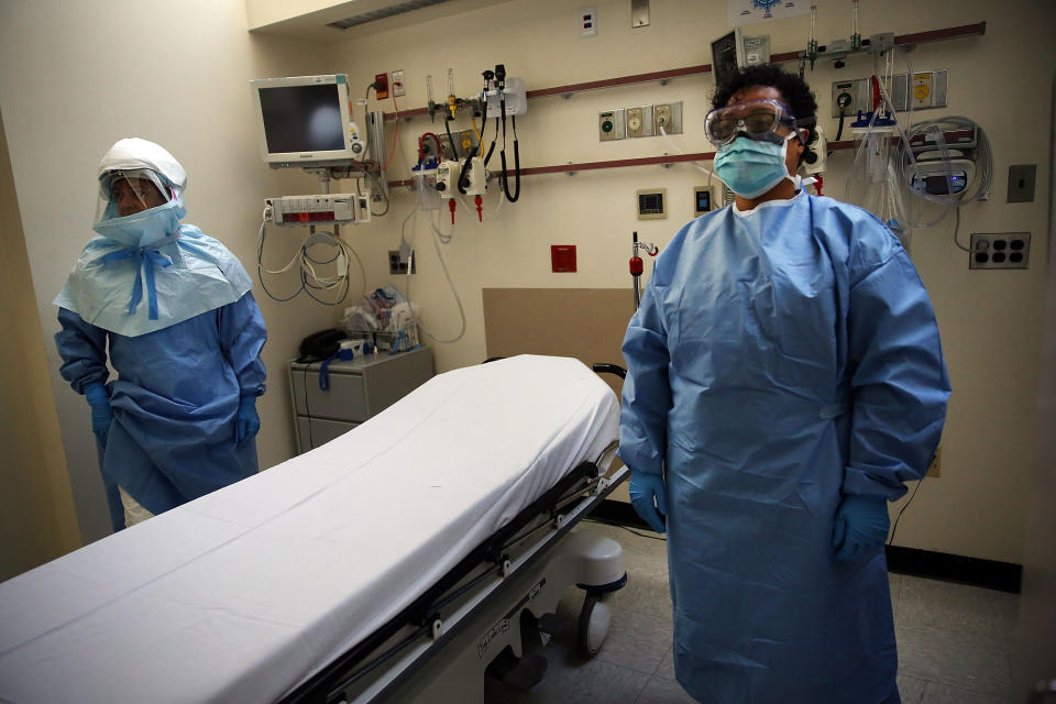 Members of Bellevue Hospital staff wear protective clothing as they demonstrate how they would receive a suspected Ebola patient on October 8, 2014 in New York City.