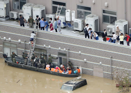 Local resident are rescued from a flooded area at a hospital in Kurashiki, Okayama Prefecture, Japan, in this photo taken by Kyodo July 8, 2018. Mandatory credit Kyodo/via REUTERS