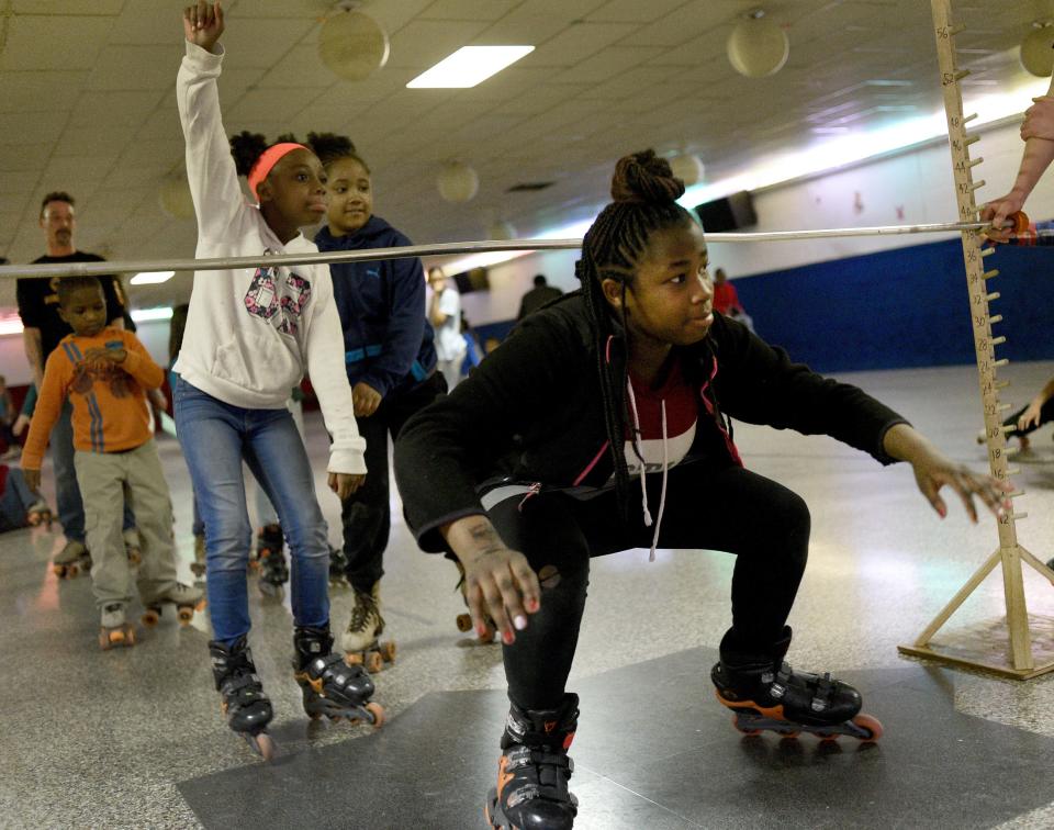 Taken in 2019, Ayonah Jones, then 11, skates underneath the limbo stick as the youth enjoy the Oaks of Righteousness Christian Ministries family skate night at Dixie Skateland.