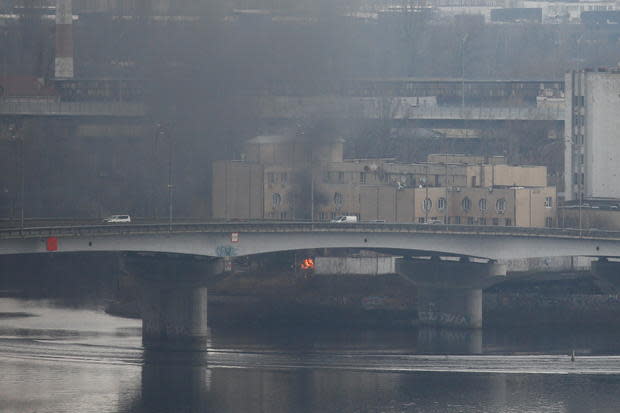 Smoke rises from near the Ukrainian Defense Ministry's intelligence unit, after Russian President Vladimir Putin launched military strikes across Ukraine, in Kyiv, February 24, 2022. / Credit: VALENTYN OGIRENKO/REUTERS