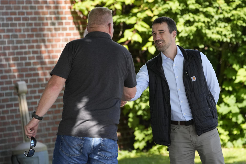 State Rep. Austin Theriault, R-Fort Kent, greets a voter, Tuesday, June 11, 2024, in Fairfield, Maine. Theriault is facing State Rep. Mike Soboleski, R-Phillips, in the Republican primary for the chance to try to unseat Jared Golden, one of the most conservative Democrats in the U.S. House of Representatives. (AP Photo/Robert F. Bukaty)