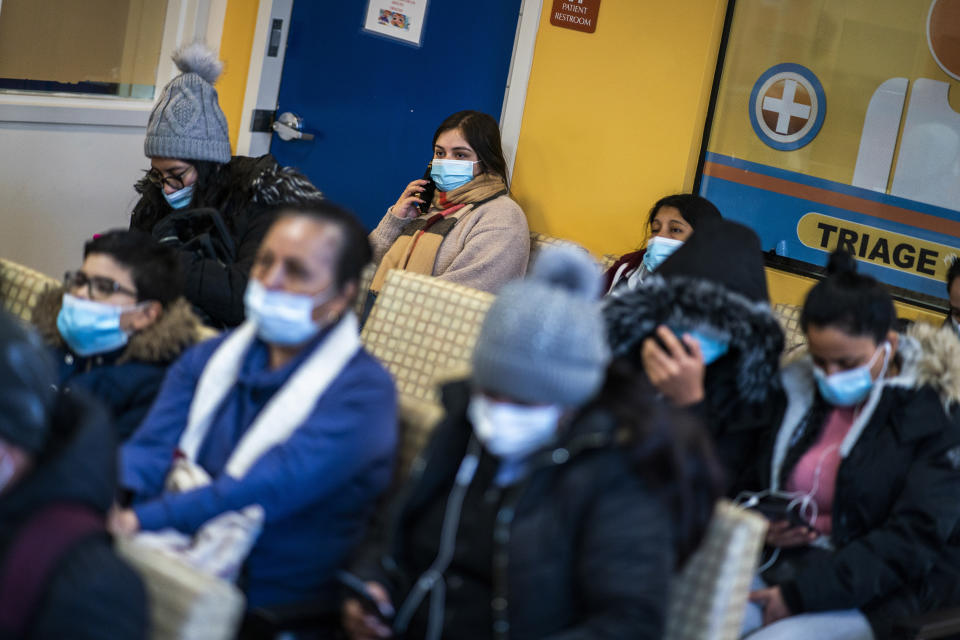 Luisa from Colombia waits with others for medical treatment at the Plaza Del Sol Family Health Center in the Queens borough in New York, Thursday, Jan. 11, 2024. (AP Photo/Eduardo Munoz Alvarez)