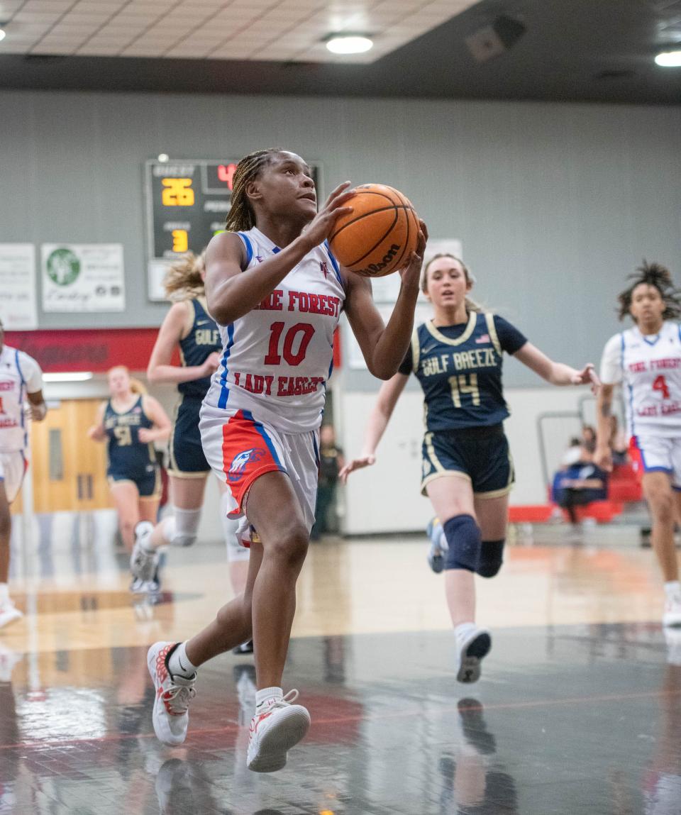 Niylia Wilkins (10) takes it to the hoop during the MLK Classic Pine Forest vs. Gulf Breeze girls basketball game at West Florida High School on Monday, Jan. 16, 2023.