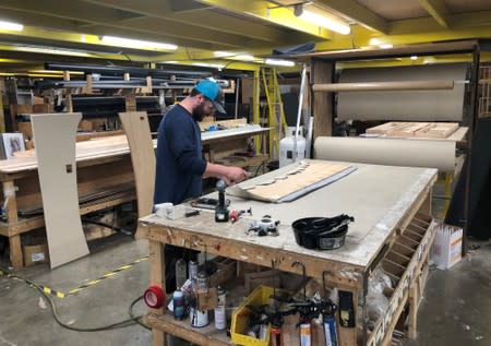 An assembly line worker works on the production line at Renegade RV manufacturing plant in Bristol, Indiana