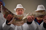 Britain's Prime Minister and Conservative Party leader Boris Johnson visits Grimsby fish market in Grimsby, northeast England, Monday Dec. 9, 2019, ahead of the general election on Dec. 12. All 650 seats in the House of Commons are up for grabs Thursday when voters will pass judgement on a divisive election that will determine Britain's future with European Union. (Ben Stansall/Pool via AP)