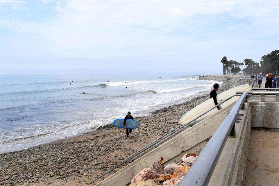 Surfers exit the water onto the Ventura Promenade on Monday. Local planners for the X Games say the city's name broadcast during the event will give the city the kind of exposure it can't pay for.