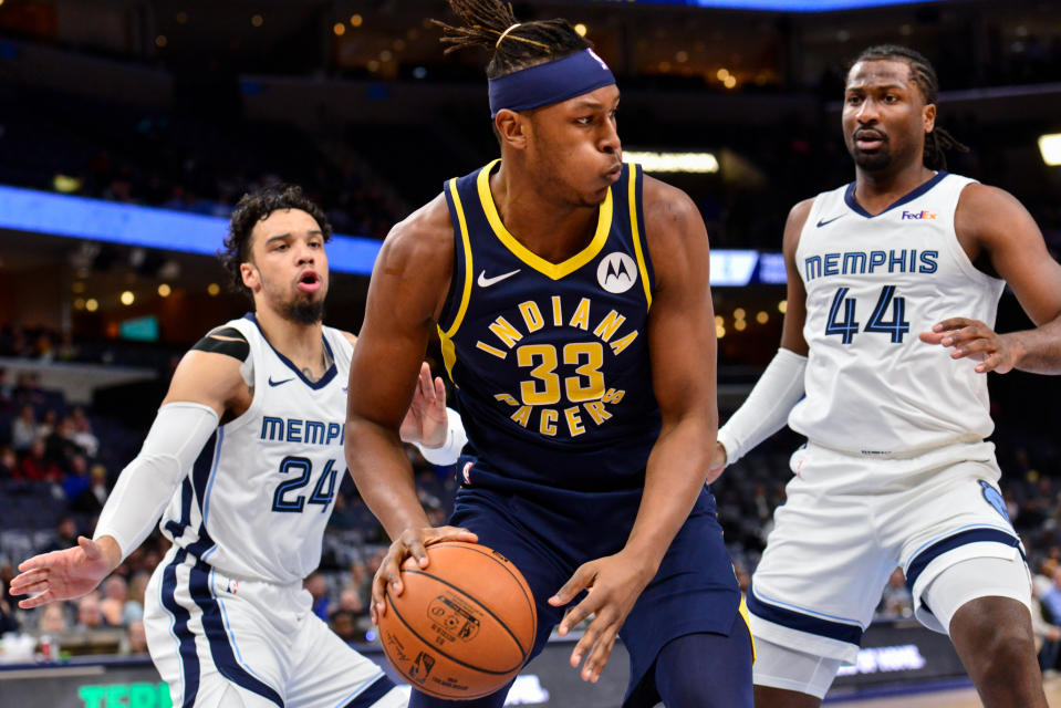 Indiana Pacers center Myles Turner (33) handles the ball against Memphis Grizzlies forward Solomon Hill (44) and guard Dillon Brooks (24)in the first half of an NBA basketball game Monday, Dec. 2, 2019, in Memphis, Tenn. (AP Photo/Brandon Dill)