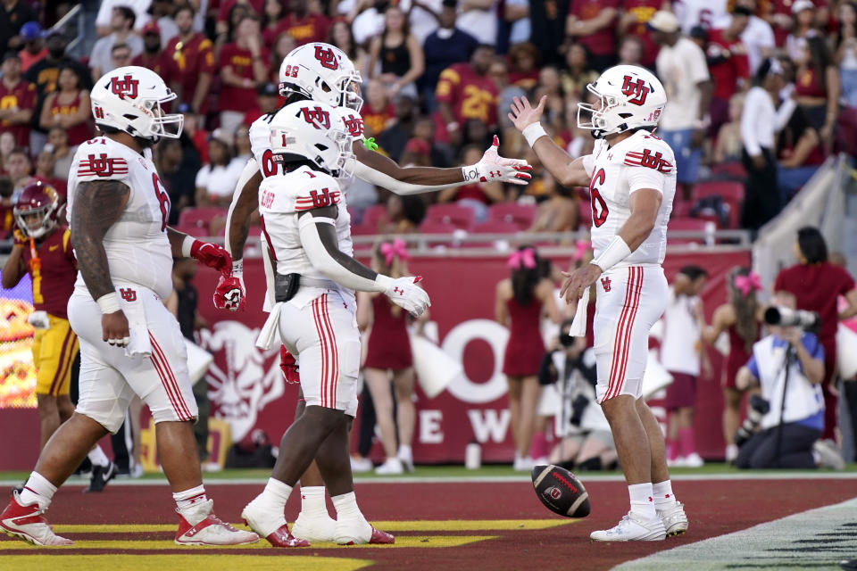 Utah quarterback Bryson Barnes (right) celebrates with teammates during a win over USC on Saturday, Oct. 21, 2023, in Los Angeles. (AP Photo/Mark J. Terrill)