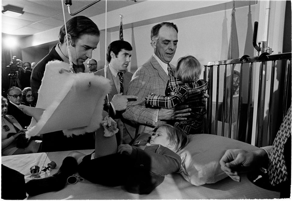 Joe Biden, left, offers words of encouragement to his bedridden son Beau before being sworn in as senator of Delaware in ceremonies at a Wilmington hospital Jan. 5, 1973.