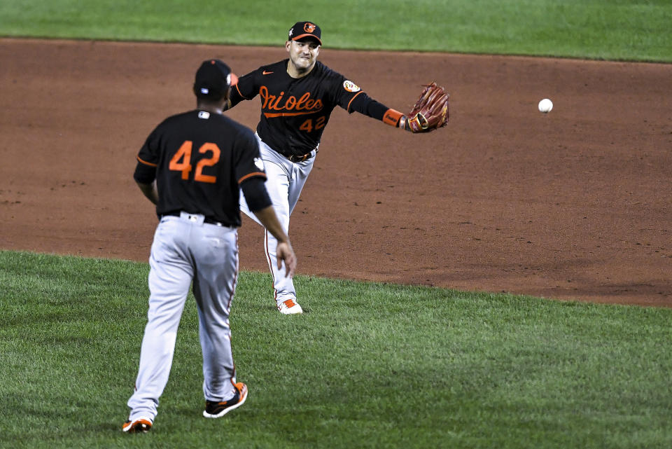 Baltimore Orioles shortstop José Iglesias flips the ball to first base with his glove after fielding a single by Toronto Blue Jays' Cavan Biggio during the sixth inning a baseball game in Buffalo, N.Y., Saturday, Aug. 29, 2020. (AP Photo/Adrian Kraus)