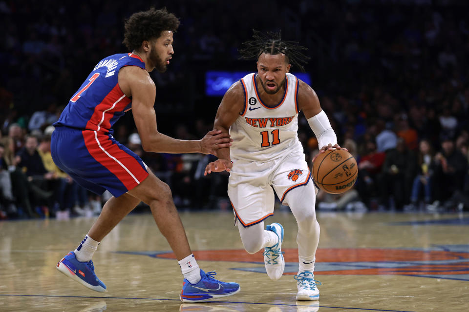 New York Knicks guard Jalen Brunson drives to the basket past Detroit Pistons guard Cade Cunningham during the second half of an NBA basketball game Friday, Oct. 21, 2022, in New York. The Knicks won 130-106. (AP Photo/Adam Hunger)