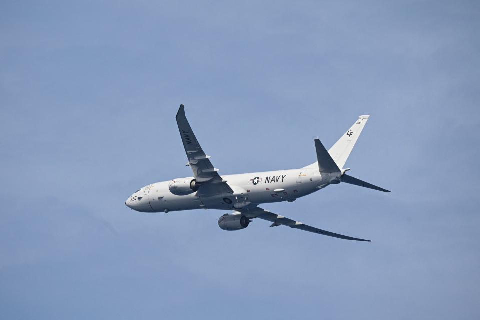 A photo of a US Navy plane in the sky.