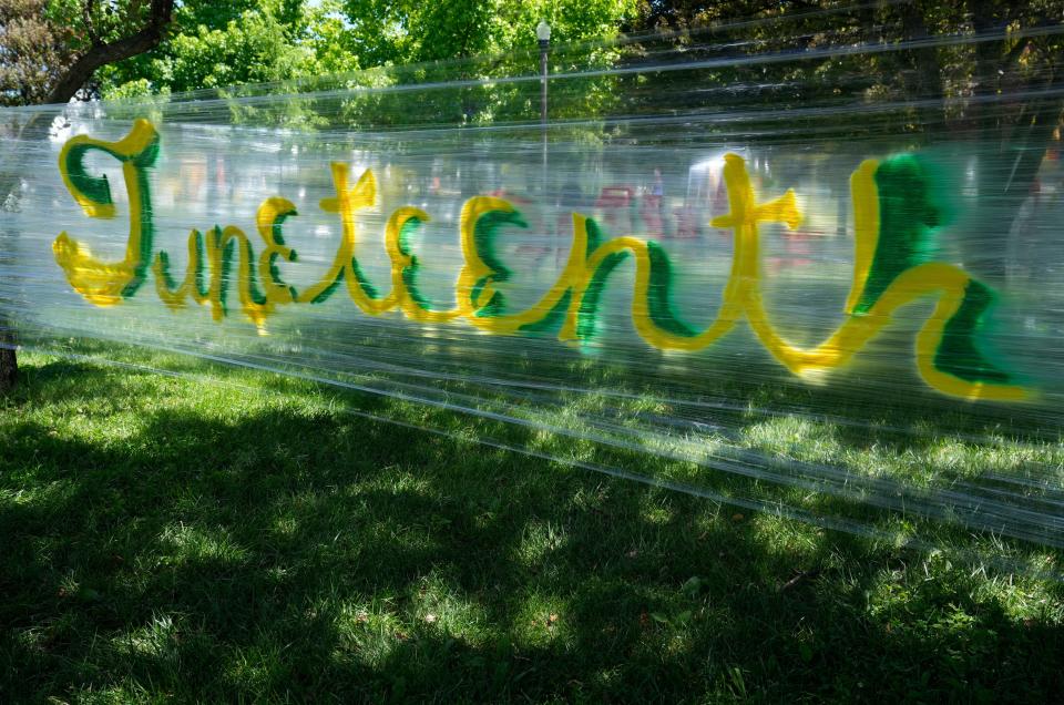 A temporary mural wall is decorated with graffiti art during the first annual Juneteenth on the Avenue on Saturday along Mount Vernon Avenue in Columbus.