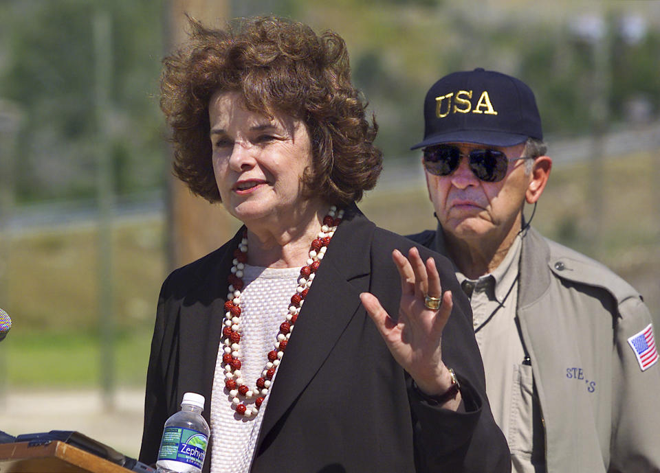 FILE - U.S. Sen. Dianne Feinstein, D-Calif., speaks to reporters just outside Camp X-Ray, where al-Qaida and Taliban prisoners are being held, at the U.S. Naval Base at Guantanamo Bay, Cuba, Sunday, Jan. 27, 2002. Feinstein and Sen. Ted Stevens, R-Alaska, at right, joined Secretary of Defense Donald Rumsfeld on a tour of the camp. (AP Photo/J. Scott Applewhite, Pool, File)