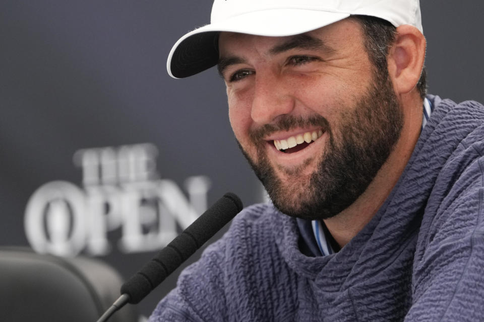 Scottie Scheffler of the United States reacts during a press conference ahead of the British Open Golf Championships at Royal Troon golf club in Troon, Scotland, Tuesday, July 16, 2024. (AP Photo/Mark Baker)