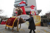 A farmer parades with a bull to celebrate the opening of this year's trading in Seoul, South Korea, Thursday, Jan. 2, 2020. Asian shares were mostly higher on optimism about a U.S.-China trade deal as most of the region's markets opened the new year's first day of trading Thursday. (AP Photo/Ahn Young-joon)