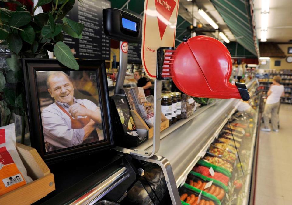 Sam Marziliano is shown in a framed photograph near where customers are encouraged to take a number at Sam’s Italian Deli and Market in this file photo from 2014. Sam Marziliano died in March 2011 but the deli continues.