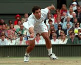 FILE - Pete Sampras reaches to return a shot from France's Cedric Pioline, during the Men's Singles Final on the Centre Court at Wimbledon, Sunday July 6, 1997.(AP Photo/Dave Caulkin, File)