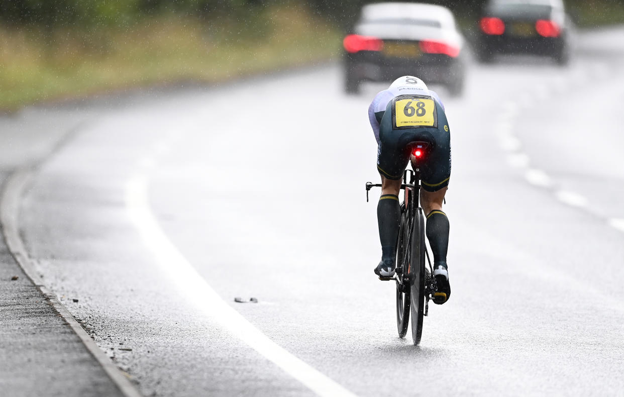  A time triallist races in a time trial on a wet dual carriageway in the UK 