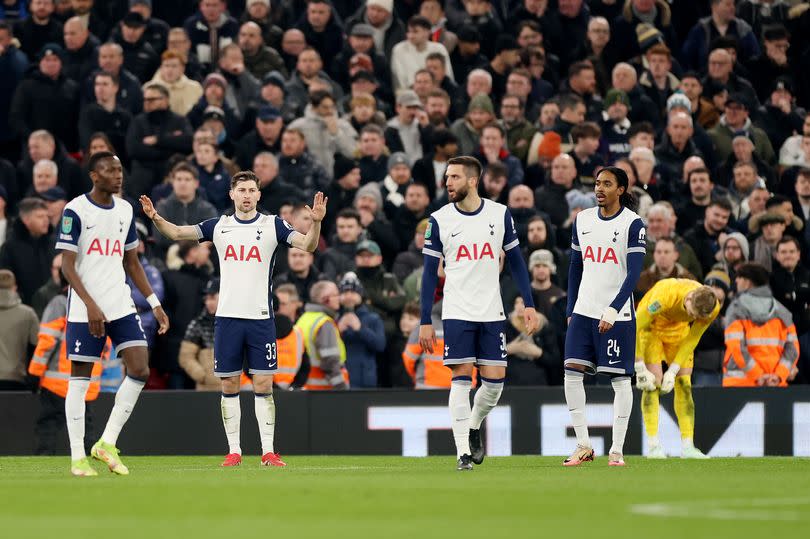 Tottenham's players look dejected after conceding against Liverpool.