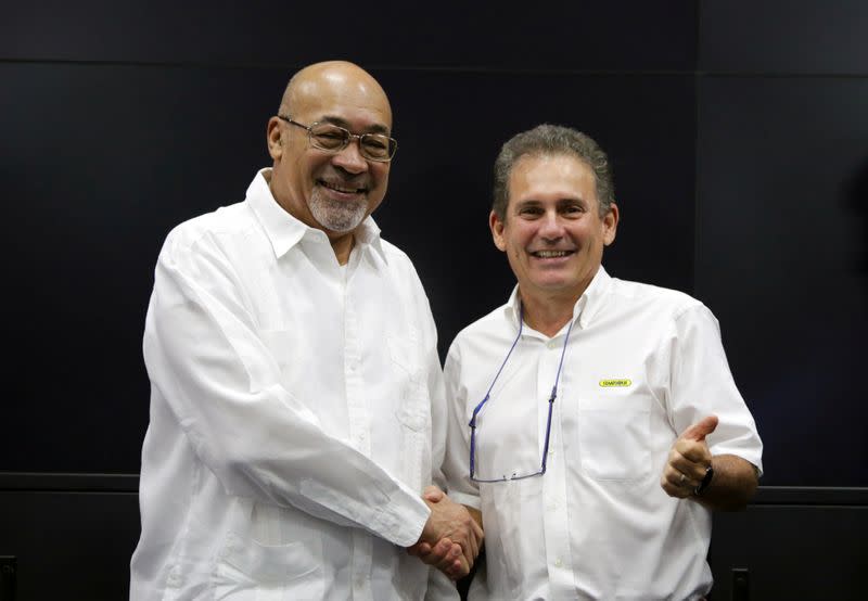 Suriname's President Desi Bouterse and Rudolf Elias, director of Suriname's state-owned oil company Staatsolie, shake hands after a news conference announcing that Apache Corporation and Total made a major oil discovery offshore Suriname, in Paramaribo