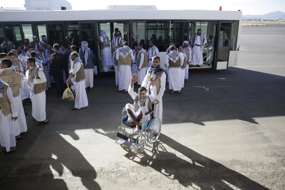 A Yemeni prisoner, center, gestures during his arrival with his fellows after being released by the Saudi-led coalition in the airport of Sanaa, Yemen, Thursday, Nov. 28, 2019. The International Committee of the Red Cross says over a hundred rebel prisoners released by the Saudi-led coalition have returned to Houthi-controlled territory in Yemen, a step toward a long-anticipated prisoner swap between the warring parties. (AP Photo/Hani Mohammed)