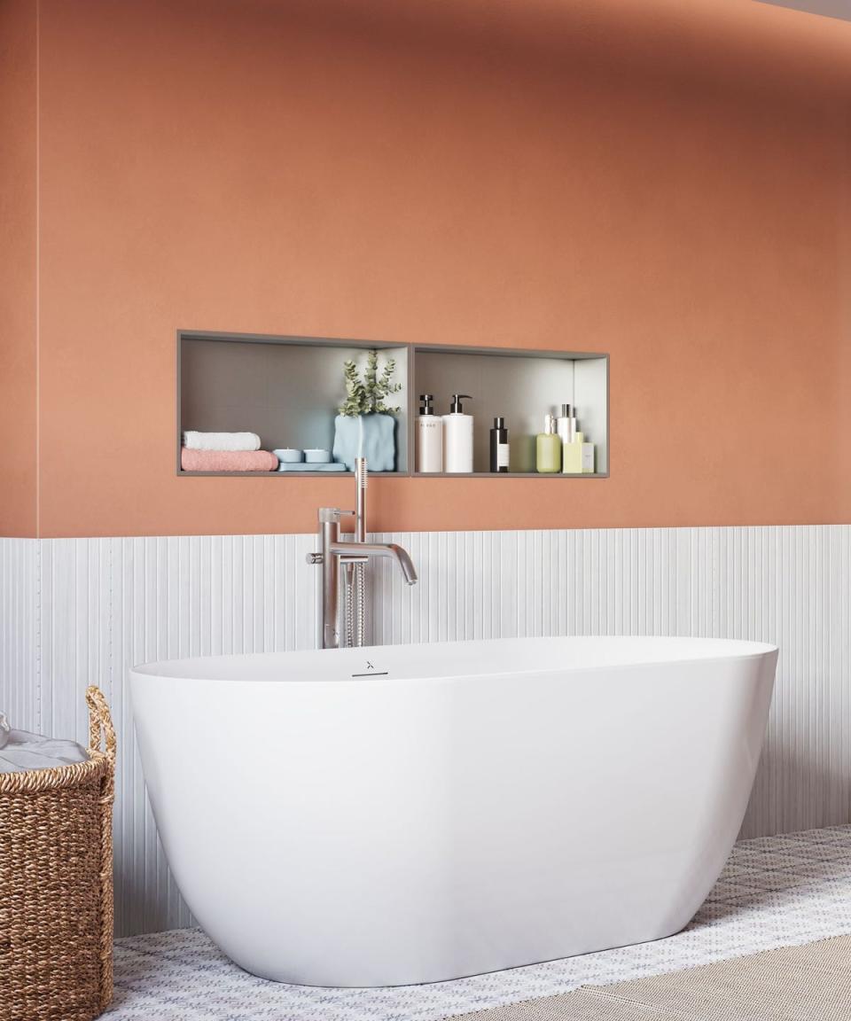 bathroom with orange walls and a silver niche storing hand towels and soaps