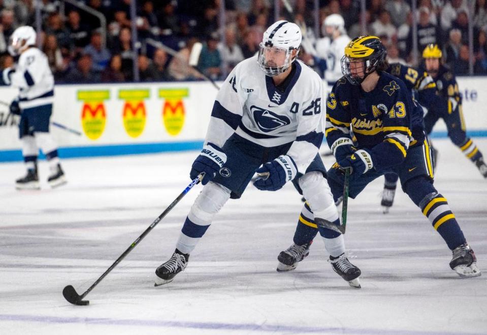 Penn State’s Tyler Gratton skates down the ice with the puck ahead of a Michigan defender during the game on Friday, Nov. 4, 2022 at Pegula Ice Arena.