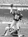 FILE - In this Jan. 22, 1983, file photo, Drew Pearson (88) of the Dallas Cowboys holds the ball after scoring their first touchdown against the Washington Redskins during the NFC Championship game at RFK Stadium in Washington. Redskins' Jeris White sits on ground. Pearson will be inducted into the Pro Football Hall of Fame on Aug. 8, 2021. (AP Photo/File)