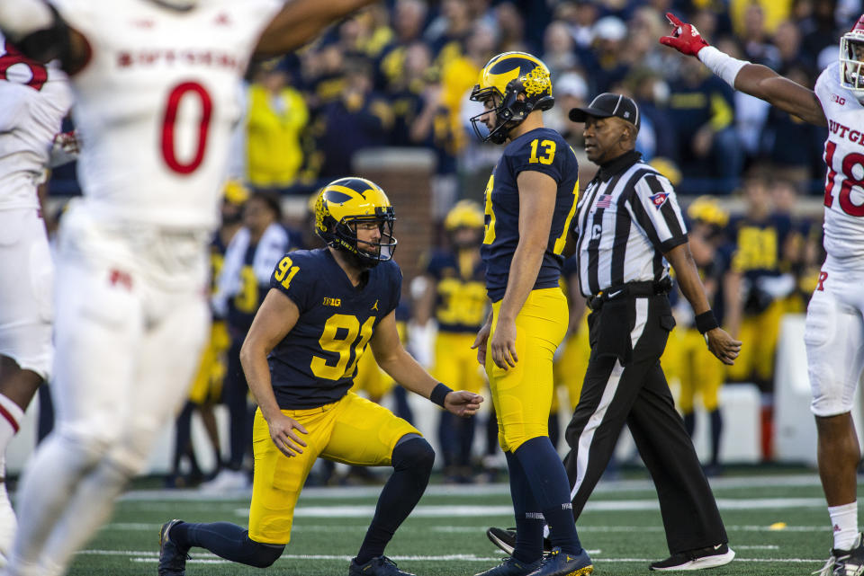 Michigan punter Brad Robbins (91) and kicker Jake Moody (13) reacts to Moody's failed attempt at a 47-yard field goal in the fourth quarter of an NCAA college football game against Rutgers in Ann Arbor, Mich., Saturday, Sept. 25, 2021. Michigan won 20-13. (AP Photo/Tony Ding)