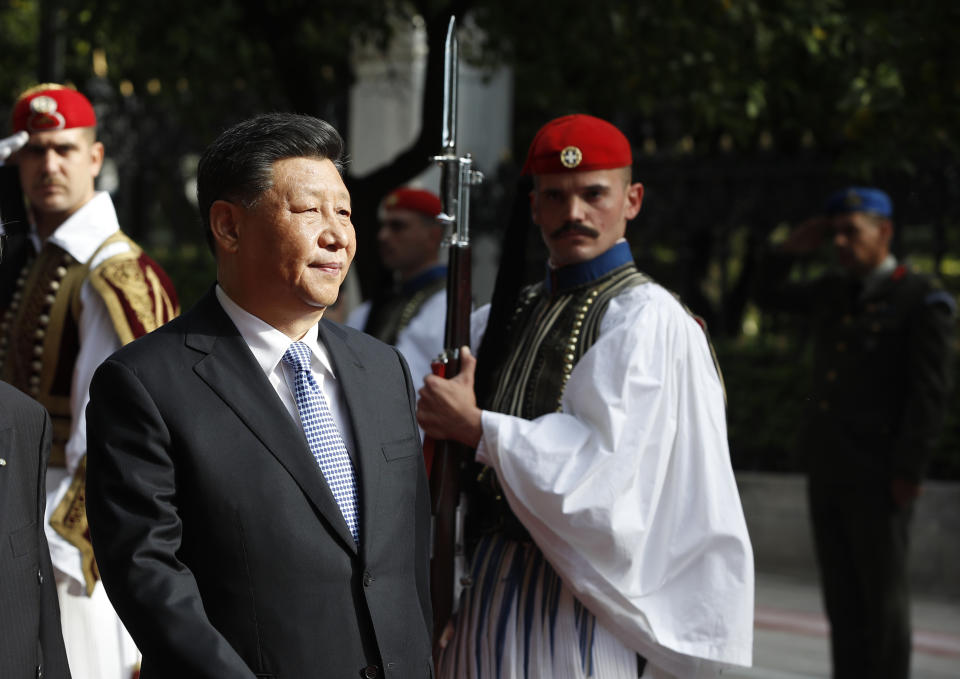 China's President Xi Jinping inspects the guard of honor by Evzones, the Greek Presidential guards, with his Greek counterpart Prokopis Pavlopoulos, outside the Presidential palace in Athens, Monday, Nov. 11, 2019. Xi Jinping is in Greece on a two-day official visit. (AP Photos/Thanassis Stavrakis)